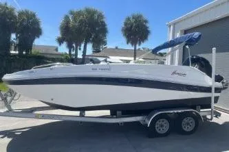 The Image of 2022 Hurricane SS 192RL boat on trailer, parked outdoors with palm trees in background. - 1