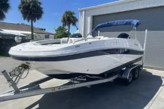 Slide: The Image of 2022 Hurricane SS 192RL boat on trailer, parked outdoors near palm trees. - 2