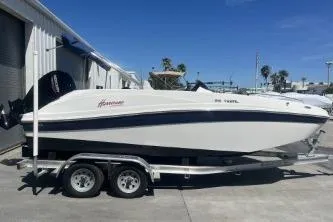 Slide: The Image of 2022 Hurricane SS 192RL boat on trailer, parked outdoors under clear blue sky. - 5