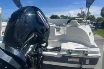 Slide: The Image of 2022 Hurricane SS 192RL boat with Mercury outboard motor, docked under clear blue sky. - 6