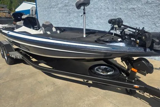 Slide: The Image of 2015 Skeeter ZX225 bass boat on trailer, parked outdoors. - 3