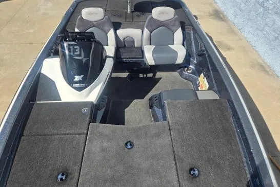 Slide: The Image of 2015 Skeeter ZX225 boat interior with dual seats and carpeted deck. - 6