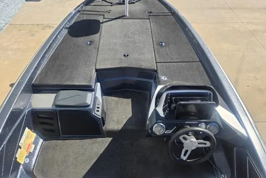 Slide: The Image of 2015 Skeeter ZX225 boat interior with steering wheel and storage compartments. - 9