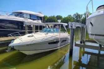 Slide: The Image of 2023 Regal 33 XO boat docked in a marina under clear blue skies. - 4