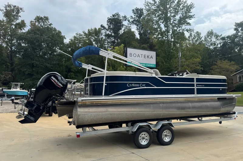 Slide: The Image of 2022 Cypress Cay Seabreeze 232 pontoon boat on trailer, outdoor setting. - 2