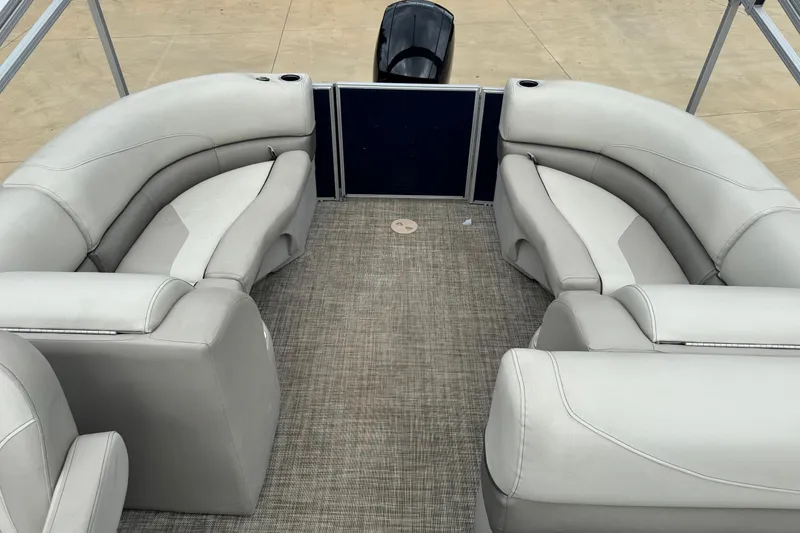 Slide: The Image of 2022 Cypress Cay Seabreeze 232 pontoon boat interior with gray seating and carpeted floor. - 6