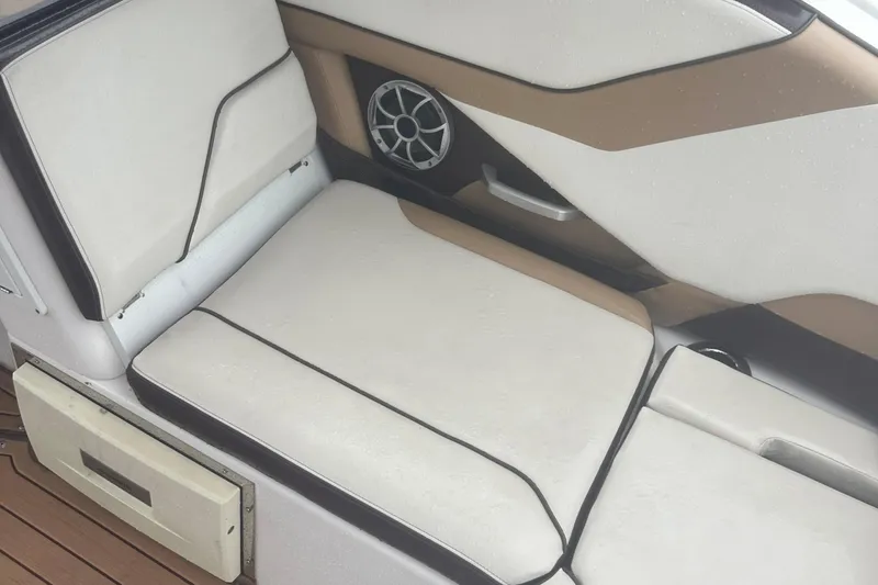 Slide: The Image of 2021 Yamaha Boats 252S interior seating with speaker and storage compartment. - 10