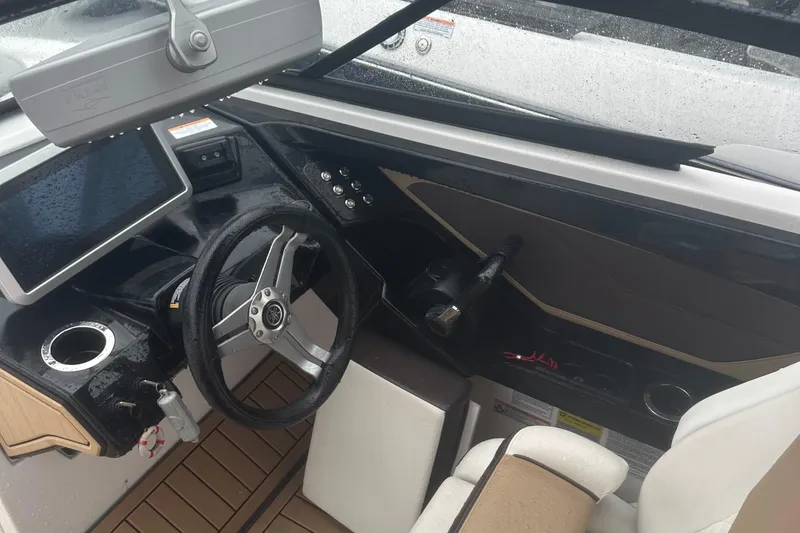 Slide: The Image of Interior view of 2021 Yamaha Boats 252S cockpit with steering wheel and controls. - 12