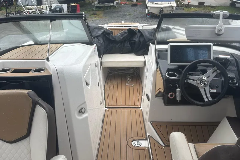 Slide: The Image of 2021 Yamaha Boats 252S interior with steering wheel, dashboard, and seating area. - 13