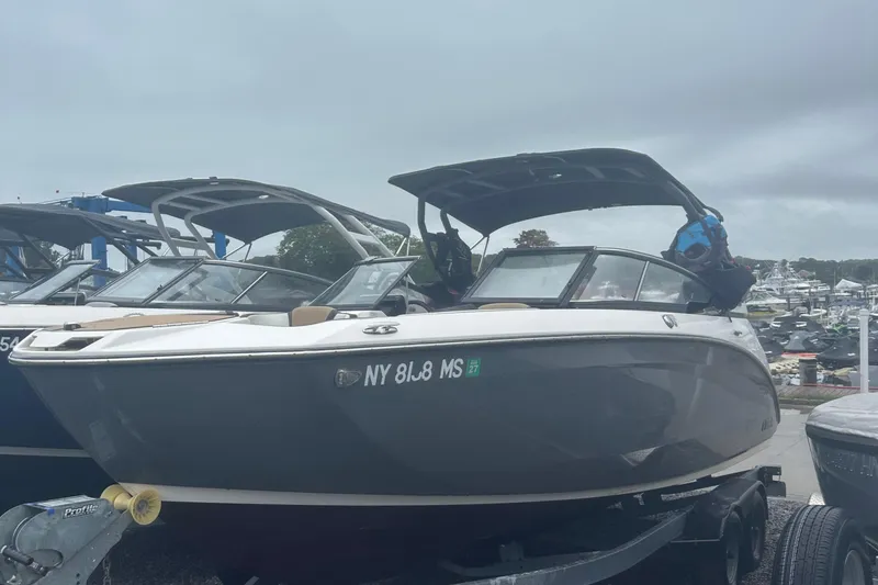 Slide: The Image of 2021 Yamaha Boats 252S on trailer at marina, overcast sky. - 2