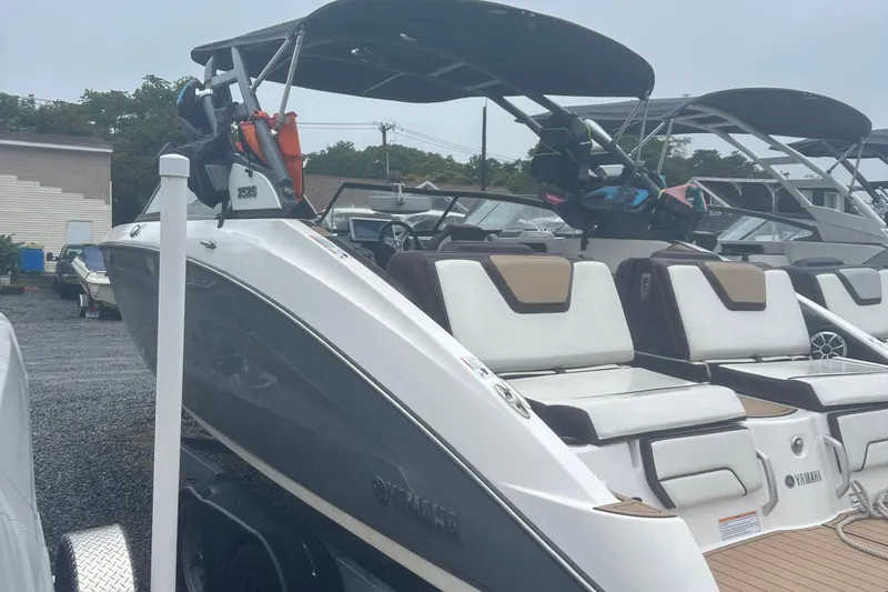 Slide: The Image of 2021 Yamaha Boats 252S with sleek design, docked in a marina setting. - 4