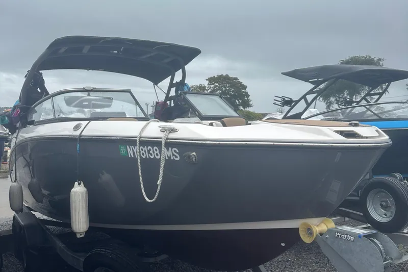 Slide: The Image of 2021 Yamaha Boats 252S on trailer, overcast sky, parked outdoors. - 5
