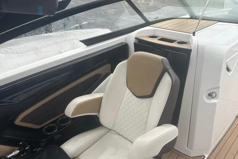 Slide: The Image of 2021 Yamaha Boats 252S interior with beige seating and cup holders. - 8