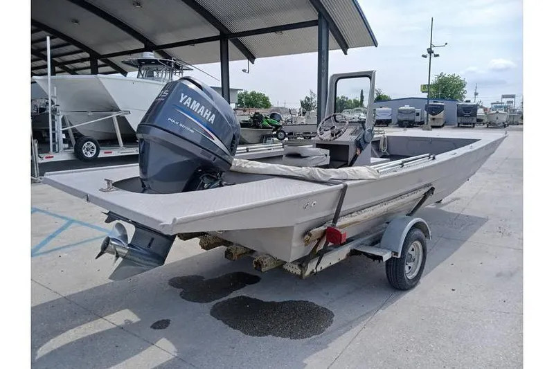 Slide: The Image of Custom 1983 boat with Yamaha outboard motor on trailer, parked outdoors. - 1