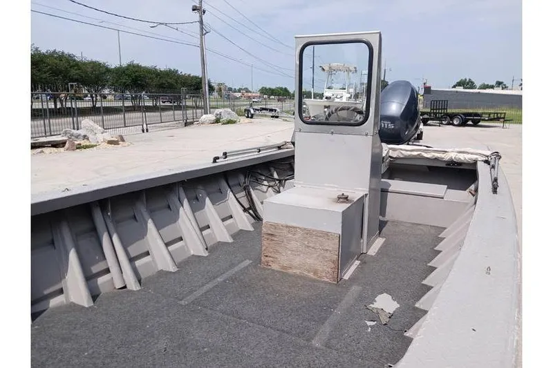 Slide: The Image of Open deck of a 1983 Custom model 18 boat with console and motor. - 10