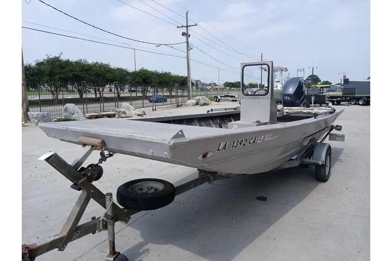 Slide: The Image of Custom 1983 boat on trailer, parked outdoors, with visible registration number. - 3
