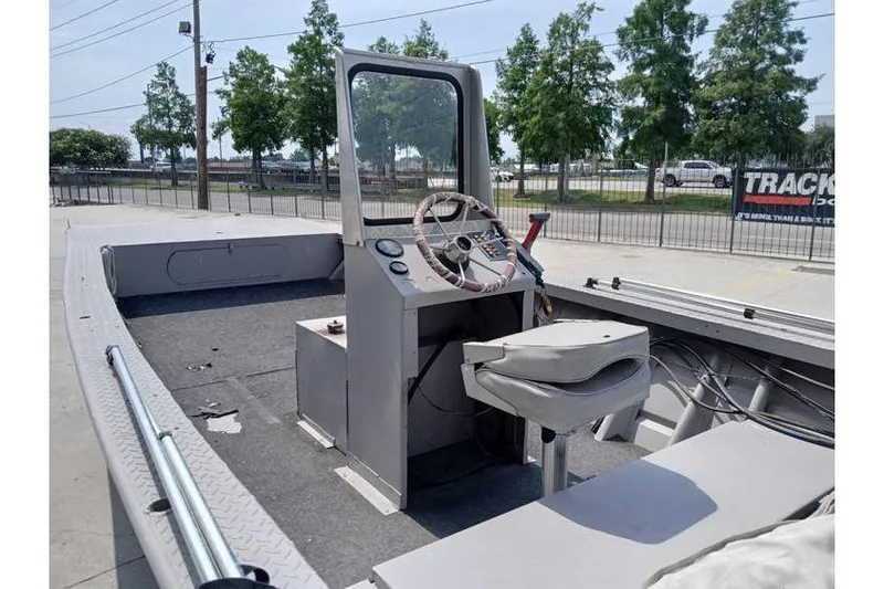 Slide: The Image of Open deck of a 1983 Custom model 18 boat with steering console and seat. - 7