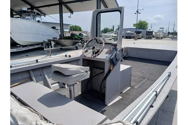 Slide: The Image of Interior of a 1983 Custom model 18 boat with steering console and seating. - 8