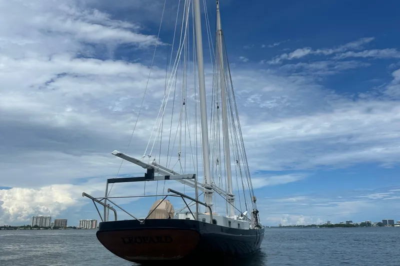 Slide: The Image of Schooner Leopard sailboat on calm waters under a partly cloudy sky, 1994 model. - 10
