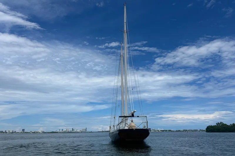 Slide: The Image of Schooner Leopard 1994 sailing on calm waters under a clear blue sky. - 13