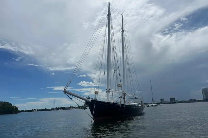 Slide: The Image of Schooner Leopard 1994 sailing in calm waters under a cloudy sky. - 14