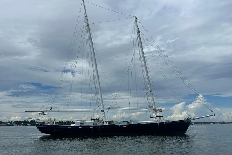 Slide: The Image of Schooner Leopard 1994 sailing vessel on calm waters under cloudy sky. - 19