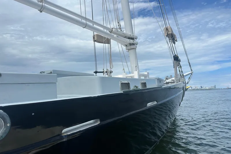 Slide: The Image of Schooner Leopard 1994 sailing on calm waters under a cloudy sky. - 21