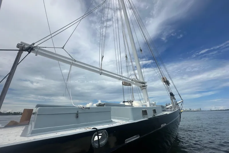 Slide: The Image of Schooner Leopard 1994 sailing vessel on calm waters under a partly cloudy sky. - 22