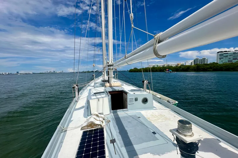 Slide: The Image of Schooner Leopard 1994 sailing on calm waters with city skyline in background. - 25