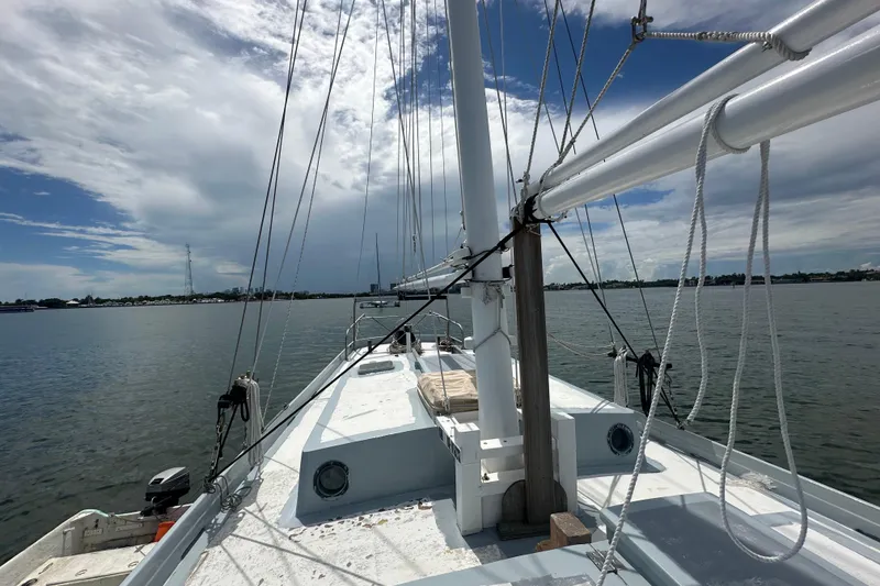 Slide: The Image of Schooner Leopard 1994 sailing on calm waters under a partly cloudy sky. - 26