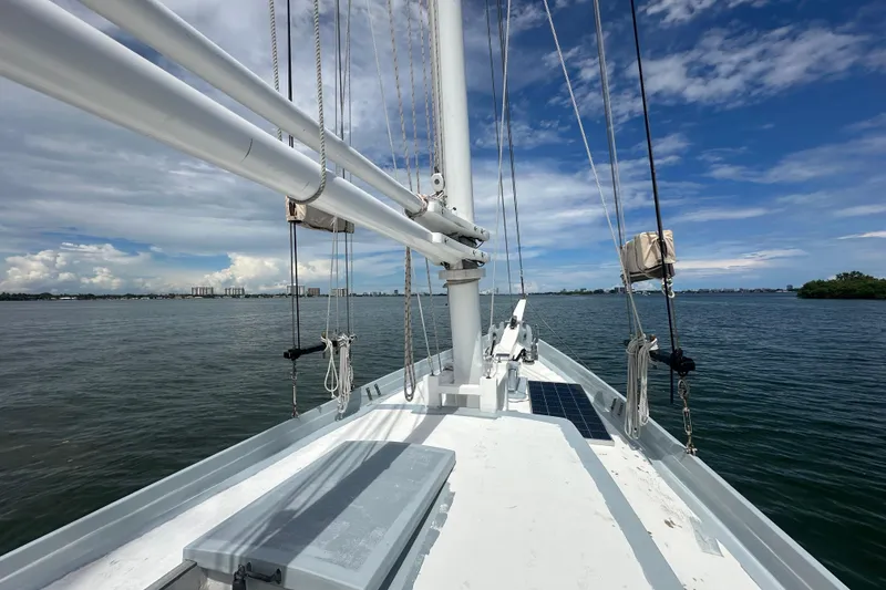 Slide: The Image of Schooner Leopard 1994 sailing on calm waters under a partly cloudy sky. - 27