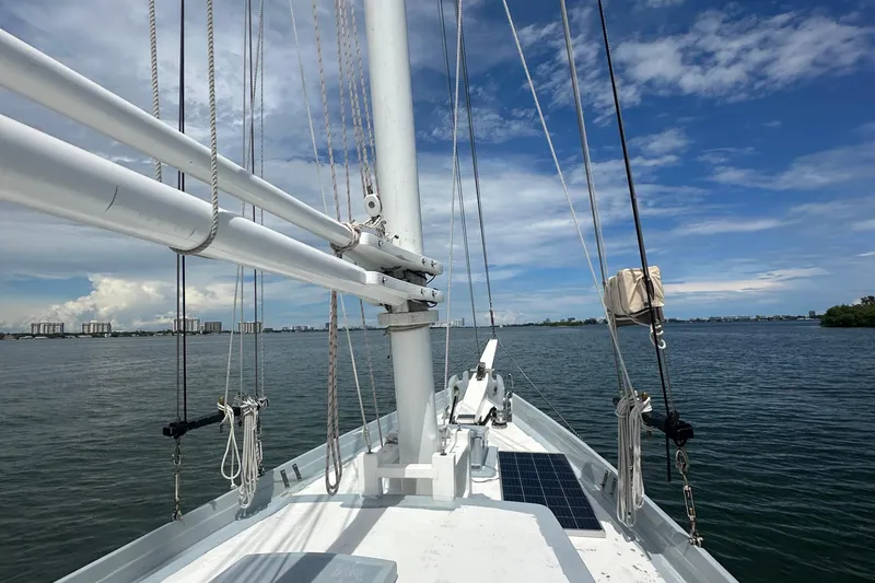 Slide: The Image of Schooner Leopard 1994 sailing on calm waters under a clear blue sky. - 28