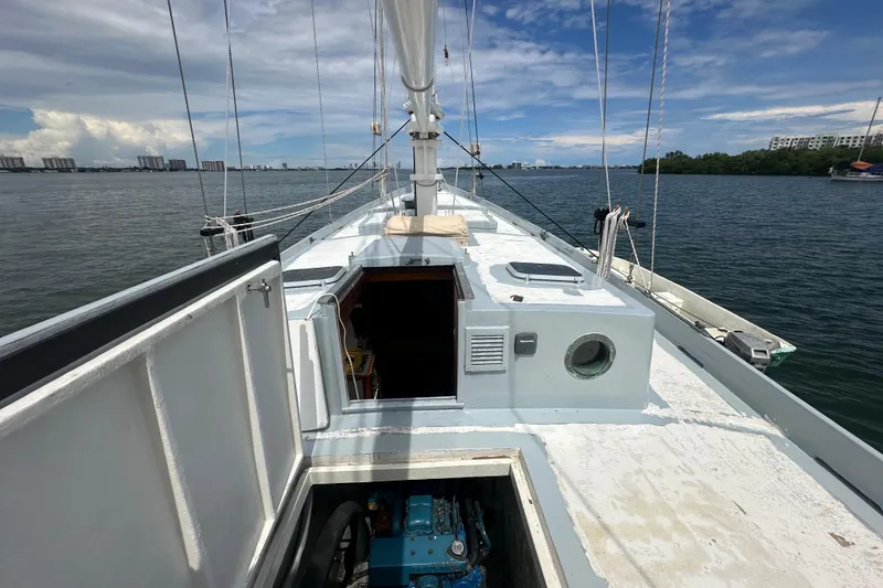 Slide: The Image of Schooner Leopard 1994 deck view with open hatch, sailing on calm waters. - 29
