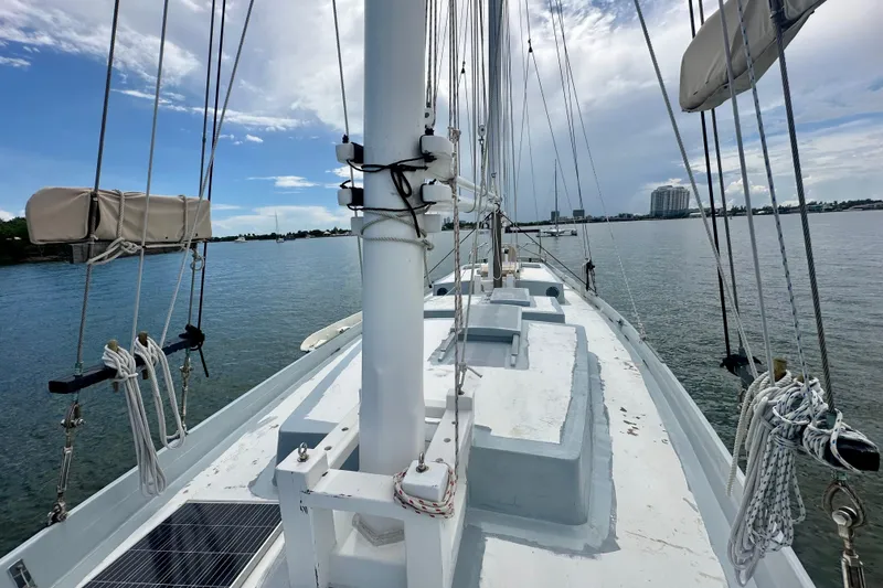Slide: The Image of Schooner Leopard 1994 sailing on calm waters under a partly cloudy sky. - 33