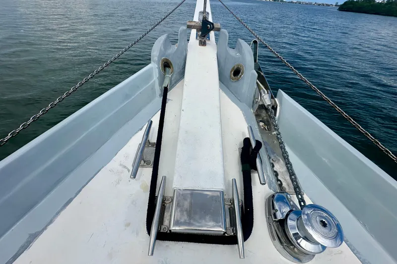 Slide: The Image of Bow of 1994 Pilot Schooner Leopard with anchor chain and winch on calm water. - 35