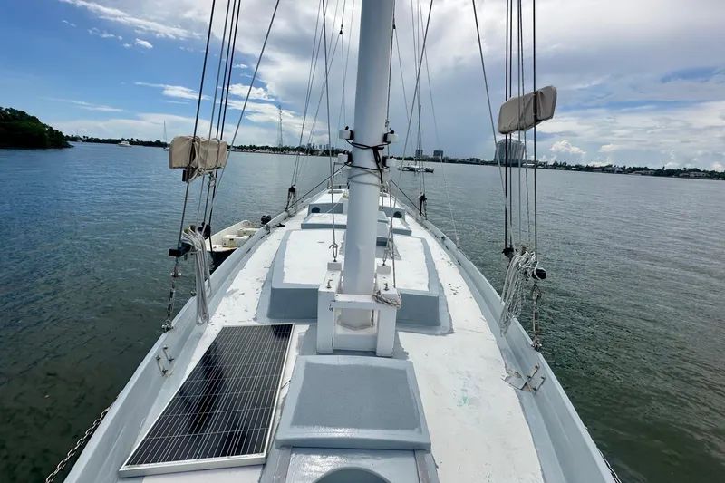 Slide: The Image of 1994 Pilot Schooner Leopard sailing on calm waters under a partly cloudy sky. - 38