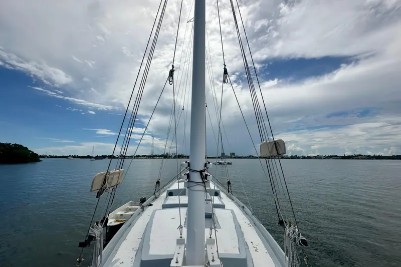 Slide: The Image of Schooner Leopard 1994 sailing on calm waters under a partly cloudy sky. - 39