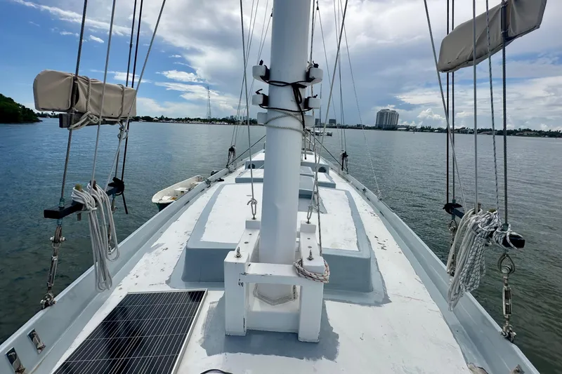 Slide: The Image of Deck view of 1994 Pilot Schooner Leopard sailboat on calm waters under a partly cloudy sky. - 40