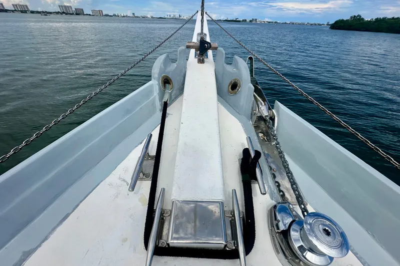 Slide: The Image of Bow of 1994 Pilot Schooner Leopard on calm water, cityscape in background. - 41