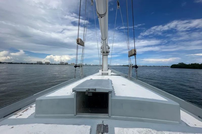 Slide: The Image of Schooner Leopard 1994 sailing on calm waters under a partly cloudy sky. - 44