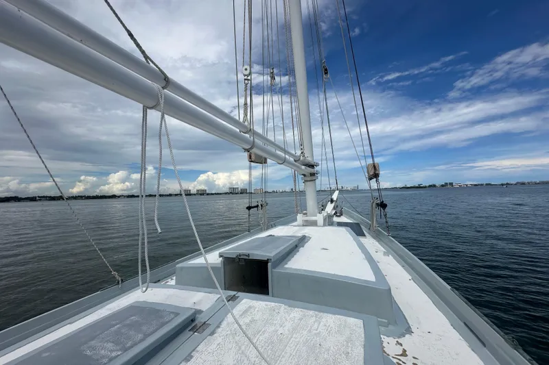 Slide: The Image of Schooner Leopard 1994 sailing on calm waters under a partly cloudy sky. - 45