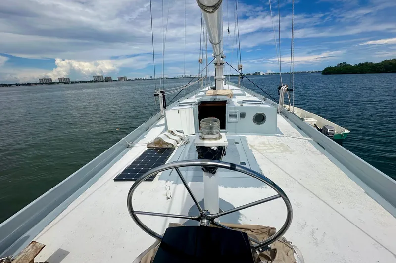 Slide: The Image of Deck view of 1994 Pilot Schooner Leopard with steering wheel and solar panel. - 48