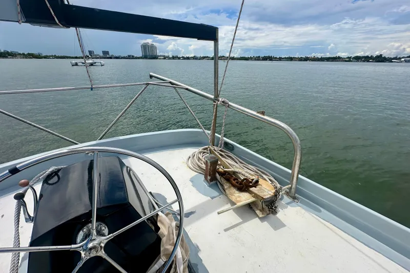 Slide: The Image of Deck view of 1994 Pilot Schooner Leopard sailboat with steering wheel and anchor. - 49