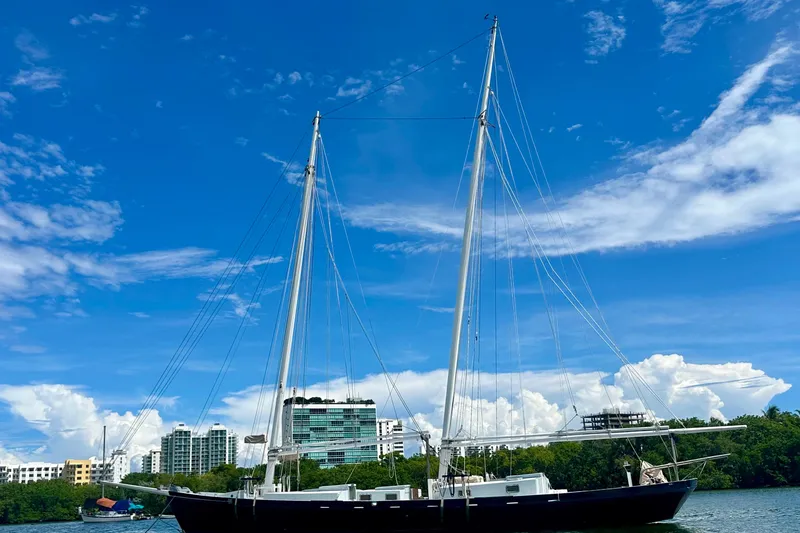 Slide: The Image of Schooner Leopard 1994 sailing near urban skyline under clear blue sky. - 5