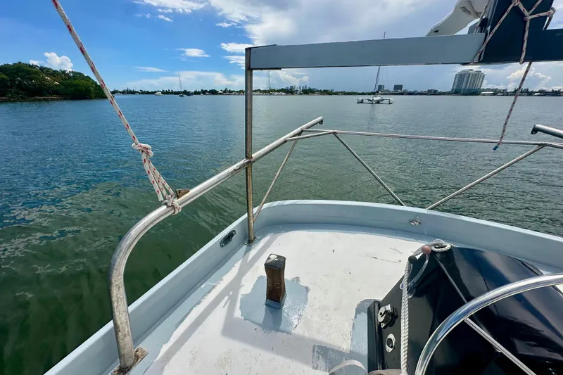 Slide: The Image of Schooner Leopard 1994 sailing on calm waters with city skyline in background. - 50