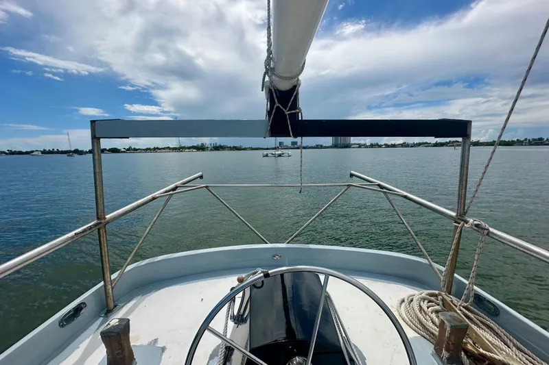 Slide: The Image of Schooner Leopard 1994 sailing on calm waters under a partly cloudy sky. - 51