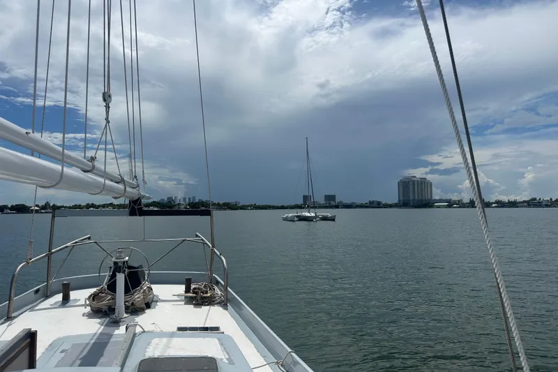 Slide: The Image of Sailing on Pilot Schooner Leopard, 1994, with city skyline and cloudy sky in background. - 54