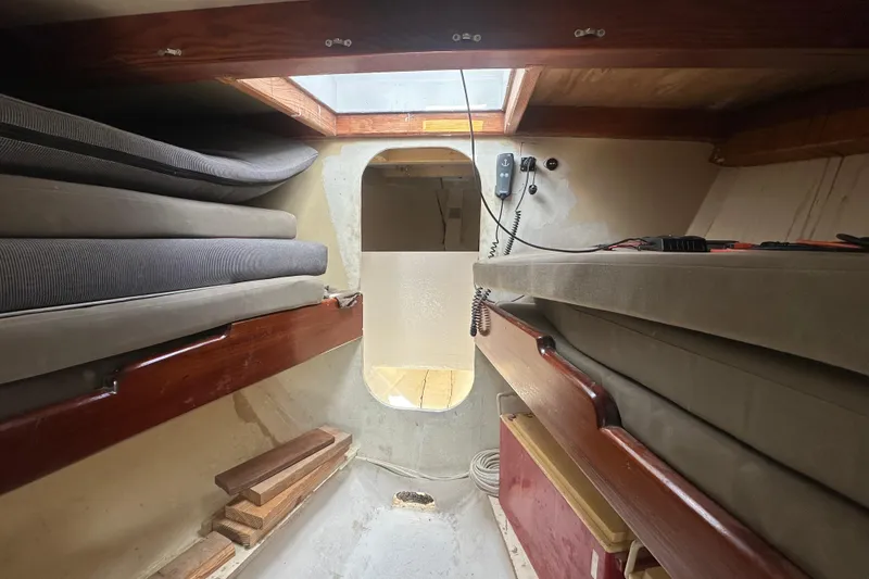 Slide: The Image of Interior of 1994 Pilot Schooner Leopard with cushions and wooden accents. - 57