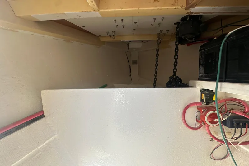 Slide: The Image of Interior view of 1994 Pilot Schooner Leopard, showcasing chains and electrical components. - 62