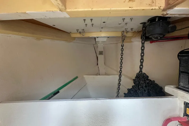 Slide: The Image of Interior view of 1994 Pilot Schooner Leopard with anchor chain and storage compartment. - 63